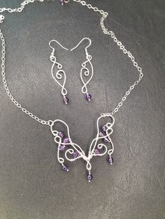 A Boho butterfly neclace in elven style for your next Renaissance fair! Made to last with .925 Sterling silver wire and Amethyst beads. The pendant is 2.25 inches wide and 2.25 inches long including the dangle on the bottom.  It's on an 18 inch chain, so the total length is about 21 inches. The dangle earrings are 2.5 inches long and 0.5 inches wide. Purple Amethyst Fantasy Jewelry, Fantasy Amethyst Silver Jewelry, Fantasy Style Silver Amethyst Jewelry, Fantasy Style Amethyst Silver Jewelry, Fantasy Style Amethyst Purple Jewelry, Fantasy Style Purple Amethyst Jewelry, Purple Wire-wrapped Silver Jewelry, Butterfly Necklace And Earrings, Elven Style