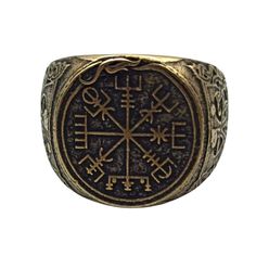 a gold and black ring with symbols on it