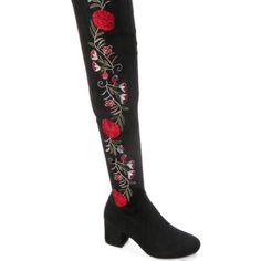 a women's black boot with red roses on the side and floral embroidered over the knee