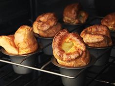 several baked goods sitting in pans on an oven rack