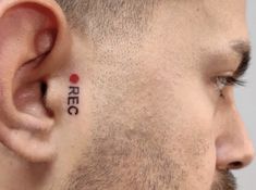 a man with a tattoo on his ear