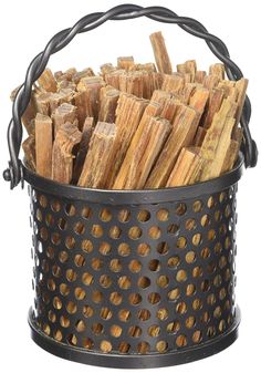 a metal bucket filled with wood sticks