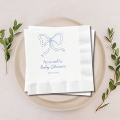 two personalized napkins sitting on top of a plate