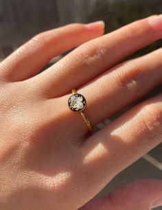 a woman's hand with a diamond ring on it