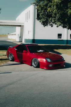 a red sports car parked in front of a building