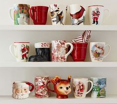 christmas mugs are lined up on the shelves