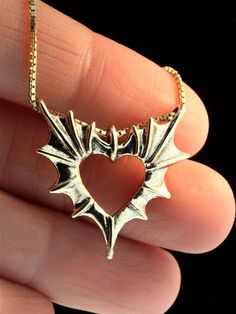 "Open your heart to Love. Two bat or dragon wings meet to form one heart. Cast in 14k gold, the Phantom Heart Pendant is 1 1/16\" wide by 1 1/8\" tall and carefully detailed both front and back. Treat yourself or gift that special someone with this wickedly wonderful token of love. This item is immediately available and ships the same or next business day. All Marty Magic Jewelry is packaged in a beautiful box, embossed with the gold foil Marty Magic dragon logo. Perfect for any occasion! Design Unique Gold Wing-shaped Jewelry, Collectible 14k Gold Heart-shaped Jewelry, Collectible Heart-shaped Jewelry For Valentine's Day, Magic Jewelry, Necklace Dragon, Dragon Logo, Magic Dragon, Bat Jewelry, Schmuck Gold