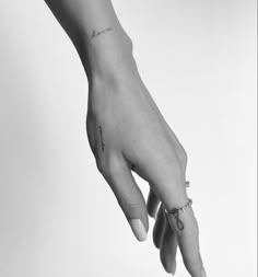 a woman's hand with a small tattoo on it