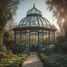 a green glass house surrounded by greenery in the middle of a park with lots of trees and bushes