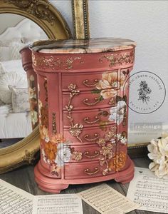 an old dresser with flowers painted on it and some music sheets scattered around the room