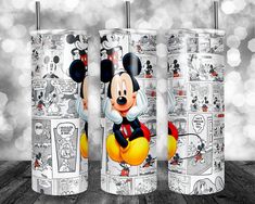 three mickey mouse tumblers are shown on a table