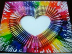 a heart made out of crayons on top of a table