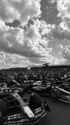 many racing cars are parked in a parking lot