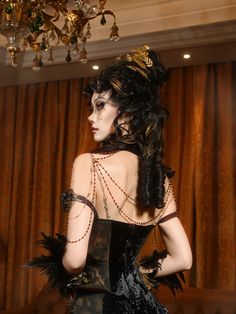 Elevate your dark elegance with our Black and Gold Victorian Goth Boned Corset. This exquisite piece features a structured, boned design that cinches the waist for a dramatic hourglass silhouette. The luxurious black fabric is contrasted by intricate gold detailing, adding a touch of regal sophistication. Adorned with removable gold roses along the hemline, this corset offers versatility and a customizable look. Perfect for gothic events, Victorian reenactments, or simply making a bold fashion s Elegant Halloween Party Corset, Gothic Corset With Corset Back For Formal Occasions, Gothic Formal Corset With Corset Back, Black Gothic Corset For Evening, Gothic Overbust Corset For Formal Occasions, Elegant Halloween Costume Corset, Gothic Boned Bodice Corset For Formal Occasions, Elegant Fitted Halloween Corset, Gothic Formal Corset With Boned Bodice