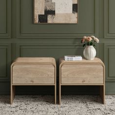 two wooden tables sitting next to each other in front of a painting on the wall