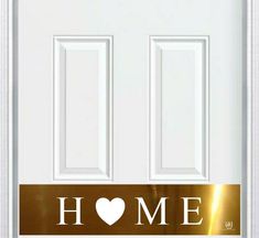 a white door with a heart on it and the words home written in gold foil