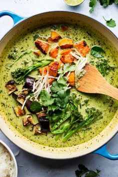 a bowl filled with broccoli and carrots next to rice