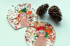 paper plate turkey craft with pine cones on the side