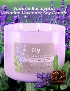 a candle with lavender and cedar in front of purple flowers