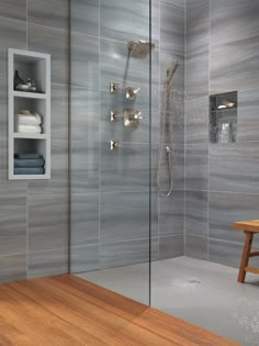 a walk in shower sitting next to a wooden bench