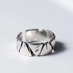 Elevate your style with this striking Geometric Silver Statement Ring. Crafted from high-quality silver, this ring features a bold, angular design that exudes modern elegance. The unique geometric pattern is both eye-catching and versatile, making it perfect for any occasion--whether you're dressing up for a special event or adding a touch of sophistication to your everyday look. This ring is designed to be adjustable, ensuring a comfortable fit for both men and women. Its minimalist aesthetic and sleek finish make it an ideal choice for those who appreciate contemporary jewelry with a distinctive edge. Key Features: Material: High-quality silver Design: Geometric angular pattern Finish: Sleek, polished silver Adjustable size: Perfect fit for any finger Unisex design: Suitable for both men Modern Irregular Rings For Gifts, Modern Adjustable Rings With Irregular Shape, Modern Adjustable Irregular Rings, Modern Sterling Silver Rings With Geometric Design, Modern Irregular Metal Rings, Minimalist Irregular Metal Jewelry, Luxury Minimalist Men's Sterling Silver Ring, Modern Irregular Shaped Metal Rings, Minimalist Silver Geometric Rings