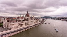 an aerial view of the hungarian parliament building in budapest, with a boat passing by