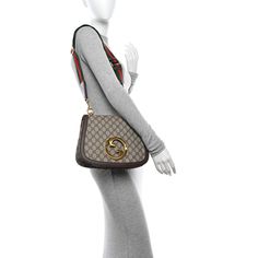 This is an authentic GUCCI GG Supreme Monogram Textured Dollar Calfskin Web Medium Blondie Shoulder Flap Bag in Beige, Ebony, and New Acero.. This stylish baguette is crafted of luxurious coated canvas brown leather. It features a looping leather shoulder strap with gold links, an optional green and red striped canvas shoulder strap, and a prominent brass Gucci interlocking GG logo at the front. The front flap opens to a beige fabric interior with a zipper pocket. Gg Logo, Beige Fabric, Green And Red, Flap Bag, Zipper Pocket, Calf Skin, Brown Leather, Shoulder Strap, Monogram