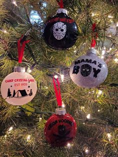 three ornaments hanging from a christmas tree in the shape of an ornament that says camp crystal lake