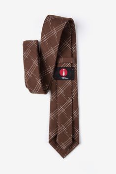 Update your wardrobe with the Escondido tie. This brown accessory features a loose checkered pattern perfect for the office and semiformal events. Imported. Classic Plaid Suit And Tie Accessories For Office, Classic Brown Ties For Office, Dapper Brown Tie For Business, Brown Semi-formal Standard Tie, Brown Standard Tie For Business, Brown Standard Tie, Brown Accessories, Brown Tie, Update Your Wardrobe