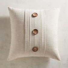 a white pillow with buttons on it