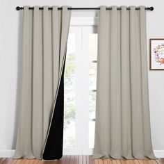 the curtains are closed in front of a window with wood floors and windowsills