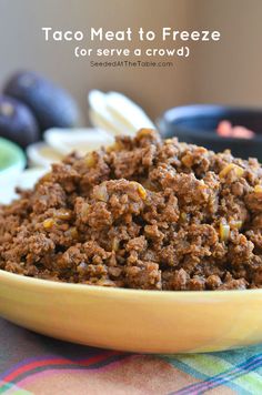 taco meat to freeze for serve in a bowl on a table with other foods