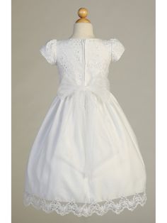 A gorgeous First Communion dress from Lito, just for your sweet girl. This embroidered lace with sequins tea length gown features short sleeves design and corded & embroidered trim on tulle skirt. Zipper back closure. A gorgeous tulle bow adorning the back of the dress. Made in USA. Elegant First Communion Dress With Short Sleeves For Pageants, Fitted Princess Dress With Lace Bodice For Confirmation, Short Sleeve Dress With Fitted Bodice For Confirmation, Fitted Short Sleeve Princess Dress For Baptism, Elegant First Communion Dress With Fitted Bodice, Elegant Short Sleeve First Communion Dress With Fitted Bodice, Elegant First Communion Dress With Short Sleeves, Fitted Short Sleeve Princess Dress For Wedding, Short Sleeve Lace Dress For Confirmation