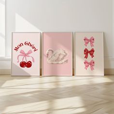 three canvases with pink bows and swans on them are displayed in an empty room