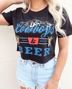 Product Details: - Material: Soft and lightweight 100% cotton - Color: Black crop top with a white and red graphic - Design: Vintage-inspired graphic with "Cowboys and Beer" phrase - Style: Crop top, perfect for pairing with high-waisted jeans or shorts - Fit: Relaxed fit with a cropped length - Size Options: Available in S, M, L, XL - Made and shipped from USA Perfect for your country concert and festivals or adding an edgy touch to your everyday look. Order yours today! Summer Concert Tops With Logo Print, Summer Concert Top With Front Print, Grunge Tops With Letter Print For Fan Merchandise, Grunge Letter Print Tops Fan Merchandise, Summer Slogan Tops For Concerts, Slogan Tops For Concerts In Summer, Summer Concert Slogan Tops, Summer Concert Slogan Top, Red Graphic Print Top For Concert