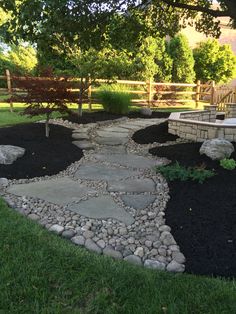 a stone path in the middle of a yard