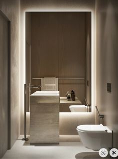 a bathroom with two sinks and a bathtub in the middle is lit by recessed lighting