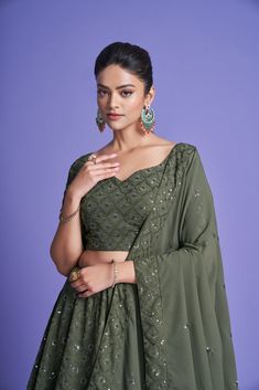 Make a statement in this 3-piece Green Diamond Georgette Thread & Sequins Embroidered Lehenga Choli Set, featuring a floor-length lehenga with 4 meters of flair, a Sweetheart Neck blouse, and a 2.30-meter Dupatta. The no-fuss outfit comes semi-stitched with a standard cancan and canvas attached; plus, customizations are available upon request. Dry Clean only and rock on, fashionista! No of Set - 3-piece set Color- Green Blouse Fabric - Diamond Georgette Blouse Sleeves-Regular Sleeves Size - 1 Me Georgette Choli With Mirror Work, Cutdana Sets For Diwali Reception, Semi-stitched Cutdana Sets For Reception, Reception Sets With Cutdana For Diwali, Festive Georgette Sets In Floor-length, Party Wear Festive Set With Unstitched Blouse, Party Wear Sets With Unstitched Blouse For Festivals, Unstitched Blouse Set For Festivals, Green Designer Party Wear Sets