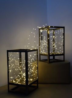 two black boxes with lights in them sitting on a table