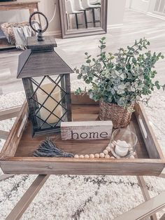 a tray with a candle and some plants on it