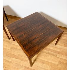 a wooden table sitting on top of a hard wood floor