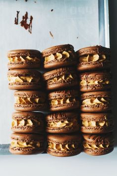 chocolate macaroons stacked on top of each other with peanut butter in the middle