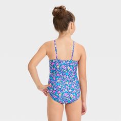 Add pretty garden charm to their swim outfits with this Ditsy Dash Floral Printed One-Piece Swimsuit from Cat & Jack™. This sleeveless one-piece swimsuit features a sweet and colorful ditsy floral print on a blue backdrop and has a cutout at front for added style. Made from stretch opaque fabric with full lining, it offers a flexible comfort and coverage both in and out of the water. The adjustable over-the-shoulder straps provide a customized fit, and the UPF 50+ rated material offers added pro Swimming Outfit, Blue Backdrops, Charming Garden, Cat & Jack, Ditsy Floral, Girls Shopping, One Piece Swimsuit, Floral Prints, One Piece