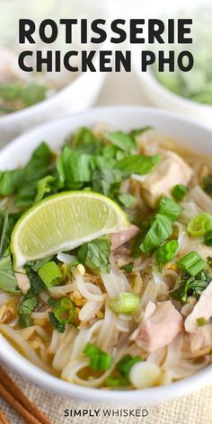 a bowl of chicken noodle soup with chopsticks and lime on the side