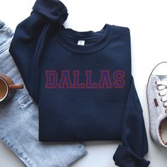 "Dallas Sweatshirt, Dallas Hoodie, Dallas Shirt, Dallas Gift, Dallas Trip, Dallas Vintage, Beautiful Dallas Production Time: 1-3 days (Typically within 2 days) Shipping Time: 2-5 days (Typically 3 days) Product Description: The Gildan UNISEX Sweatshirt (18000) and Hoodie (18500) are crafted from high-quality materials. The Gildan Heavy Blend garment offers an impeccable fit and a plush, comfortable feel.  Care Instructions: - Machine wash: warm (maximum 40C or 105F) - Use non-chlorine bleach as needed - Tumble dry: medium heat - Do not iron - Do not dry clean We care about you and the environment: - Our print chemicals are certified by \"REACH\" and \"Oeko-Tex® Standard 100 Class I\". (Oeko-Tex Standard 100 is a worldwide certification for textiles such as yarns, fabrics, buttons, linens, Navy Cotton Varsity Sweatshirt, Navy Cotton Collegiate Sweatshirt, Navy Cotton College Sweatshirt, Navy Cotton Sweatshirt For College, Cotton Sweater With Ribbed Cuffs For Game Day, Cotton Top With Ribbed Cuffs For Team Spirit, Team Spirit Long Sleeve Sweater With Letter Print, Varsity Style Cotton Sweater With Letter Print, Navy Long Sleeve Hoodie With Letter Print