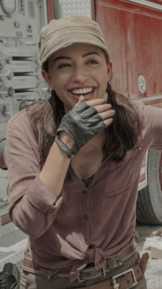 a woman wearing a hat and leather gloves