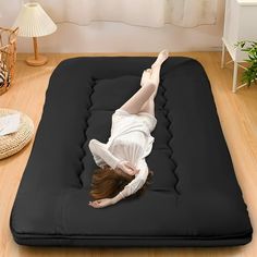 a woman laying on top of an inflatable mattress