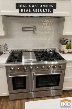 a stainless steel stove top oven sitting inside of a kitchen next to white cabinets and counter tops