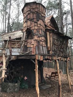 an old wooden structure in the woods