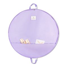 two pairs of ballet shoes are sitting on a purple round shelf with white tags attached to it